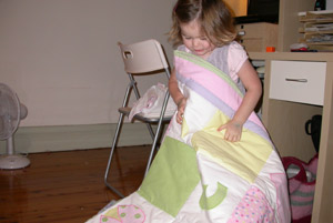 Isabelle opening her quilt